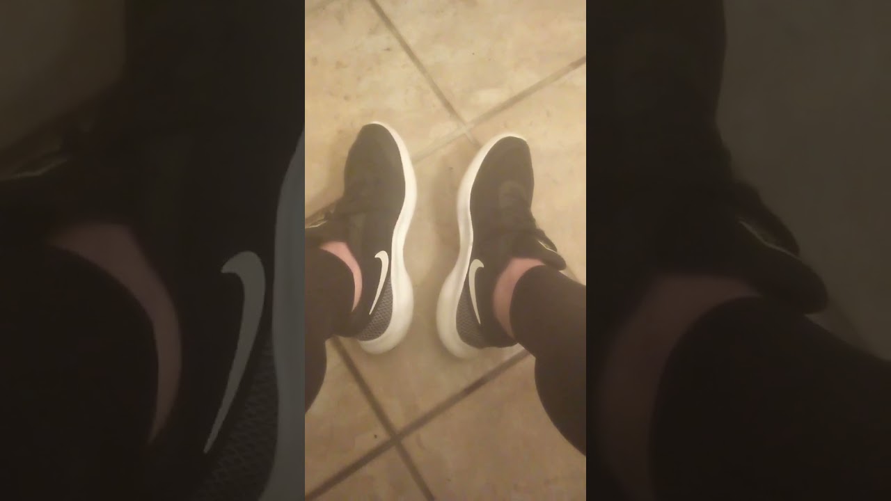 Sister wearing her black and white Nike sneakers without socks. Includes foot flexing. Her POV.