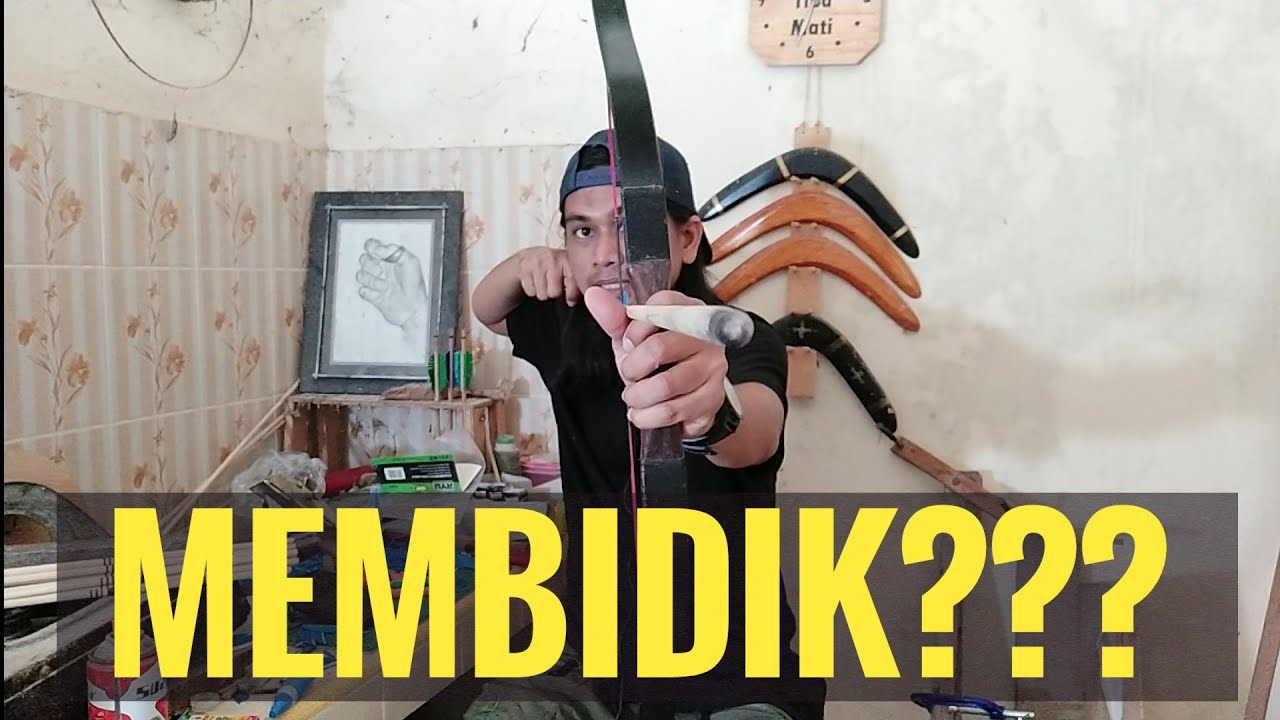 membidik dengan ujung poin anak panah atau melalui sisi busur???