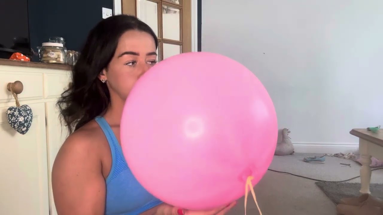 Blowing up a pink punch ball balloon
