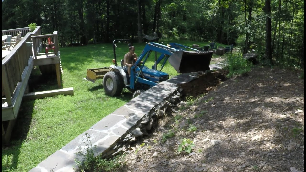 Filling dirt behind a retaining wall