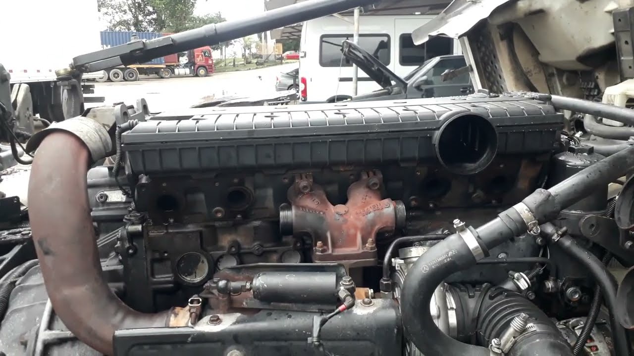 Motor Mercedes OM 926 LA. jogando diesel pelo escapamento e fumaçando branco.