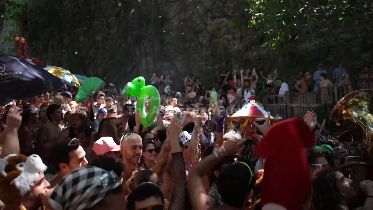 Revellers party through the streets of Rio de Janeiro ahead of Carnival