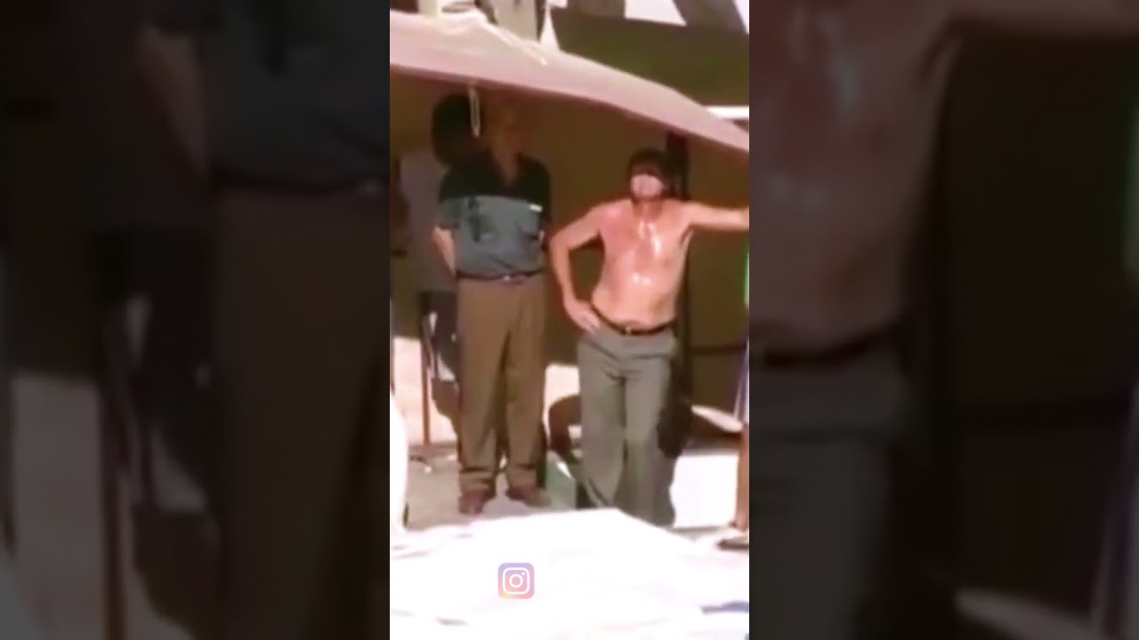 Falcioni dirigiendo a su equipo en cuero y fumando