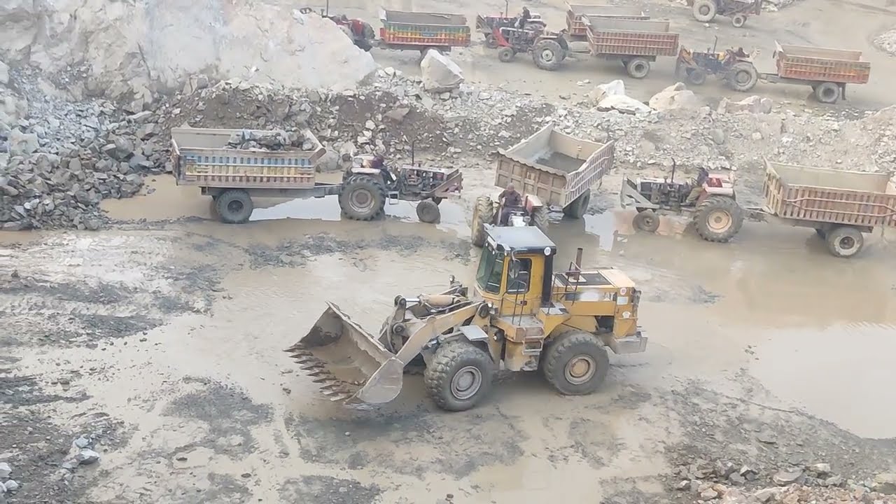 Amazing view Working in mountain: Black Stone Loading With Caterpillar Loadar into Trolley