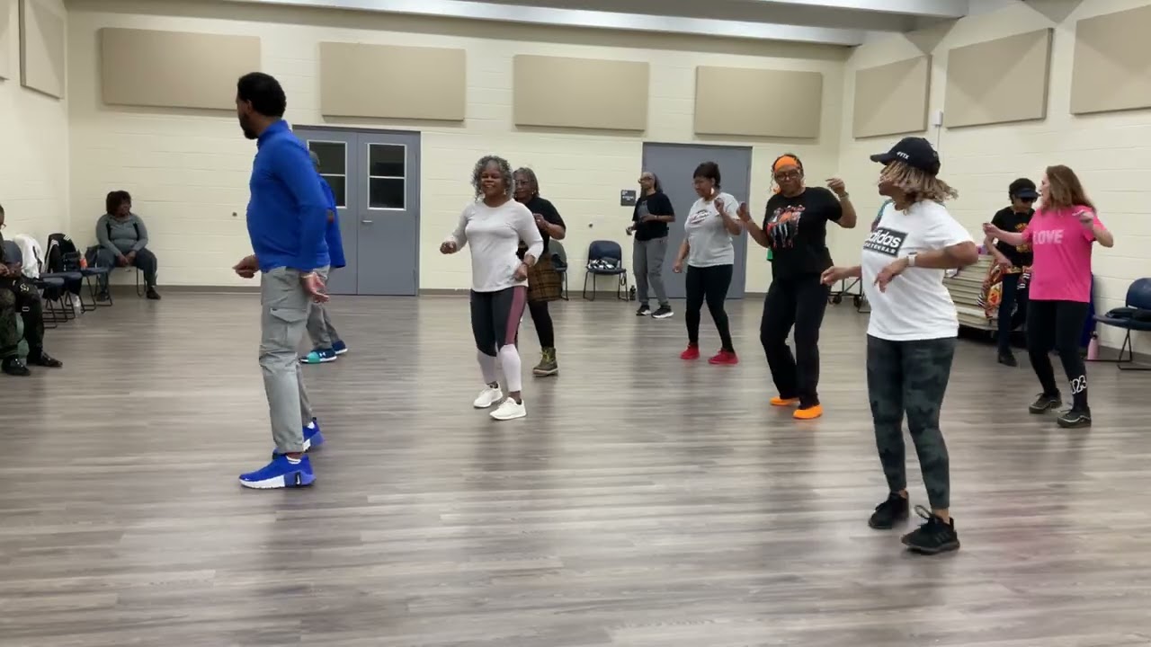 Carol instructing class on line dance,  Groove Rock