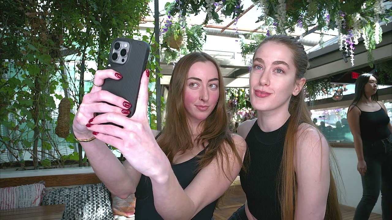 Models Audrey and Justice take selfies in front of the camera at Art Hearts Casting