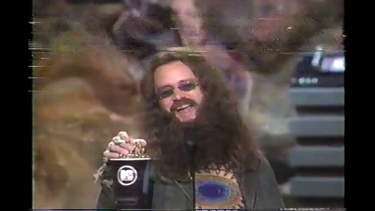 1999 MTV Movie Awards - 'Hippy' Jim Carrey accepts award with Mike Meyers and Janeane Garofalo