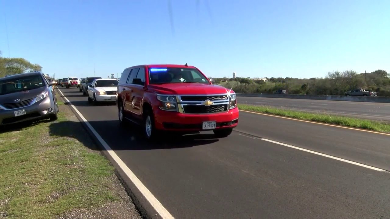 Police vehicle procession to funeral