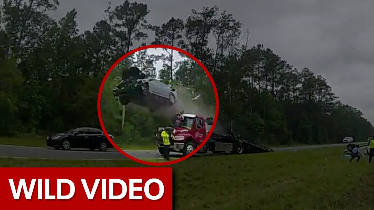 Car launches off tow truck ramp