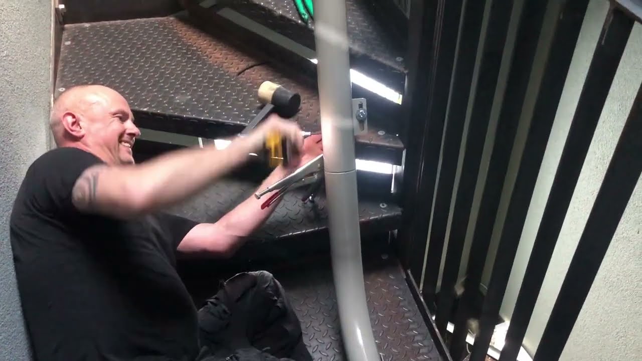 Stairlift installation on a a four-level spiral steel staircase. Stairlift fitting, spiral stairs.