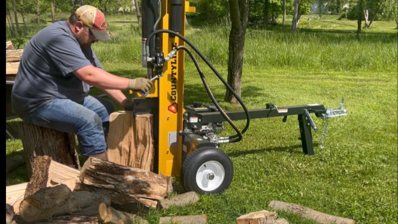 Splitting with a 25 ton CountyLine log splitter and stacking firewood