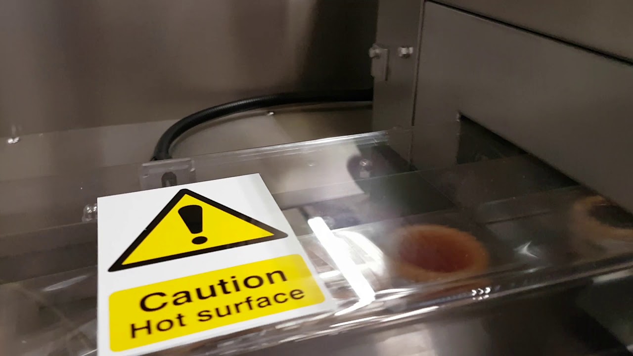 Redpack P325E with automatic infeed flowrapping cakes at 110 packs per minute.