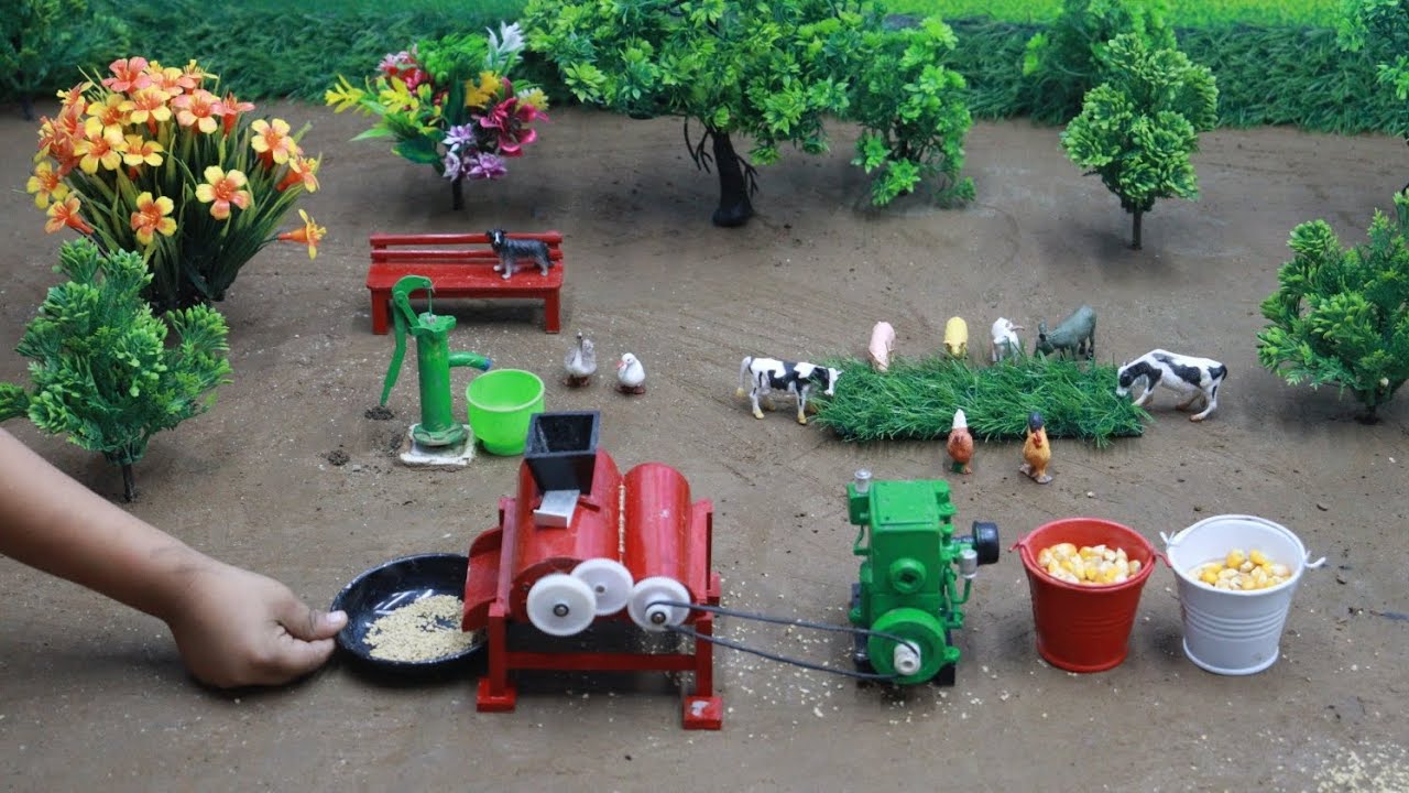 A little man is grinding corn in a mill and feeding it to cows, goats, horses, and other animals. 
