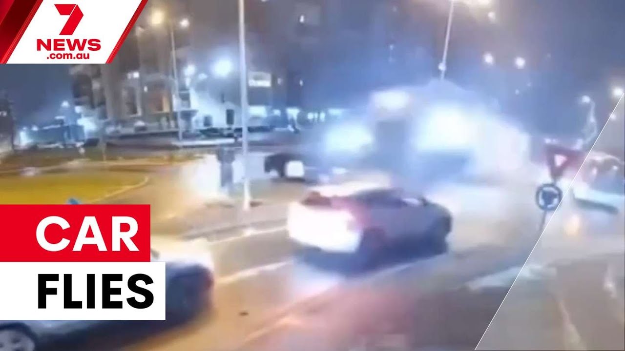 Car launches over roundabout in Romania | 7NEWS