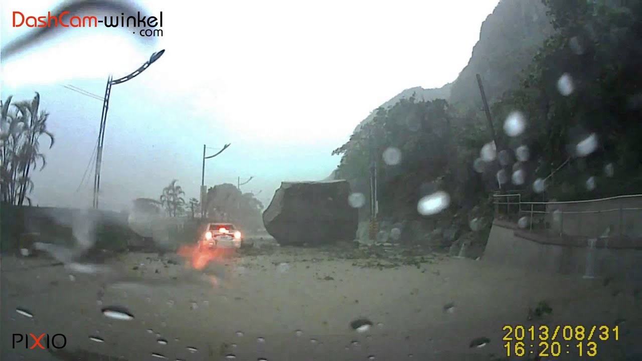 Massive rock falling on car