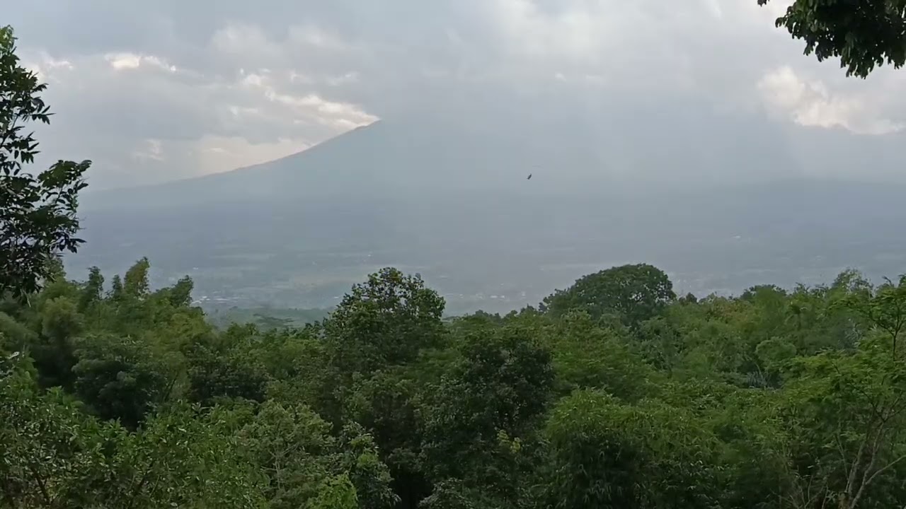 Dark Clouds Above The Mountain Penetrated by The Sun