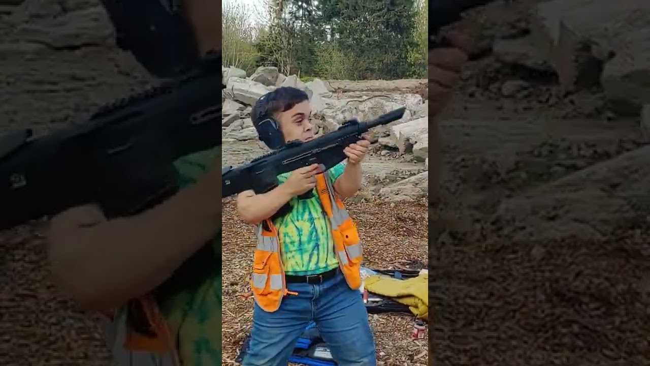 Shooting a 12 gauge bullpup shotgun over shoulder 