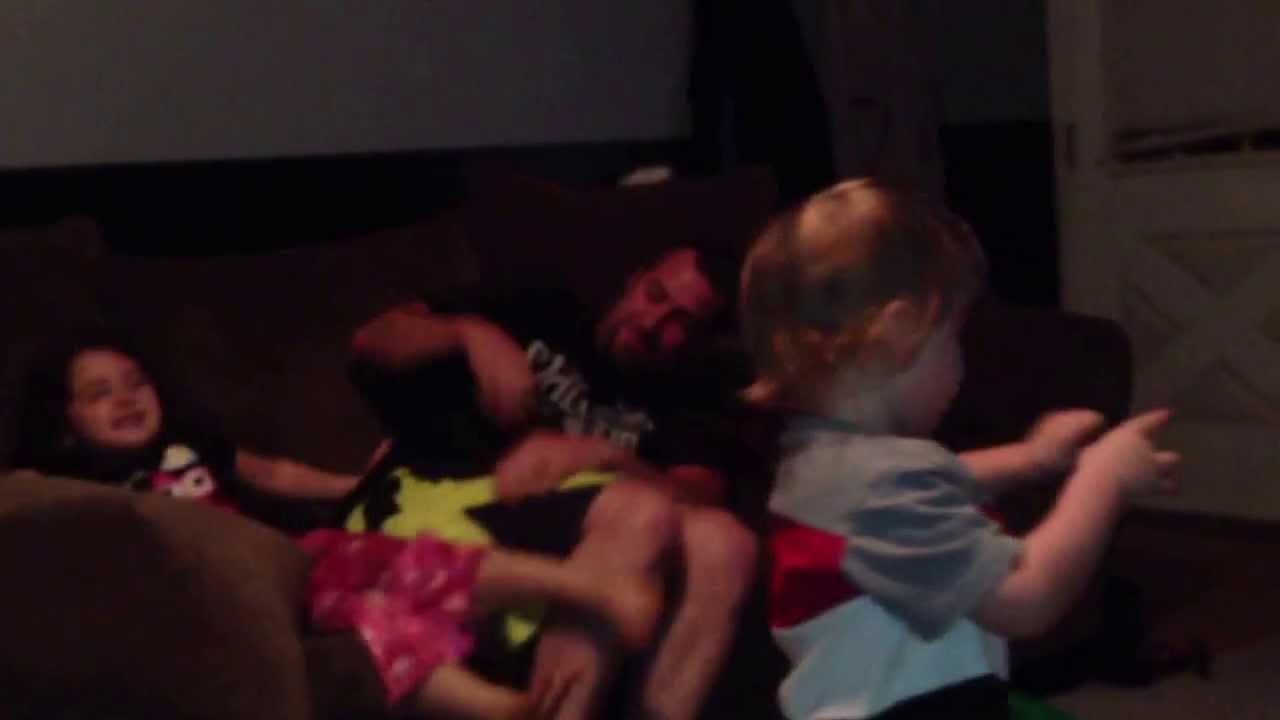 Kids wrestling with their dad