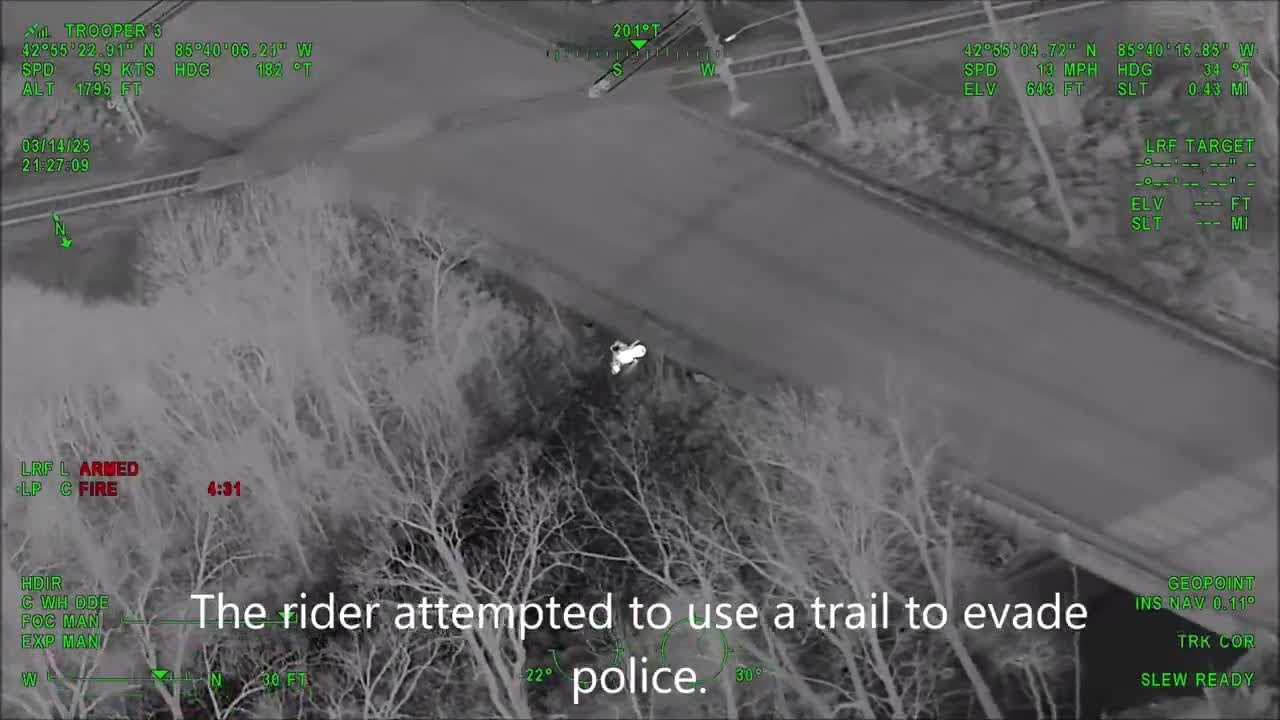 Police pursuit of motorcyclist on a nature trail