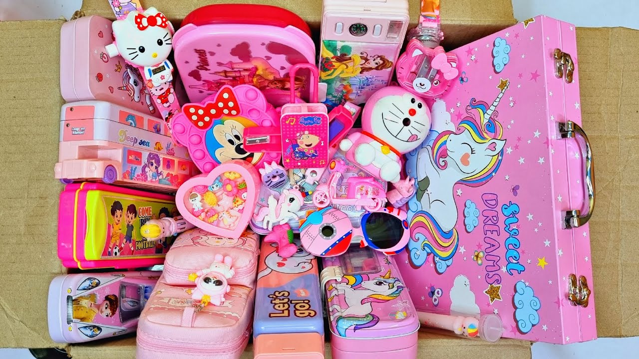 Box full of pink stationery - doraemon sharpner, password lock pencil box, projector watch, eraser
