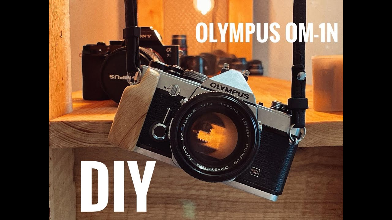 Olympus OM-1n DIY wood hand with pine. Film camera at the 2025