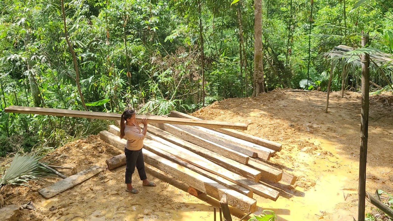 The girl's house was burned down by bad guys and she had to dig and move wood to build a new house.