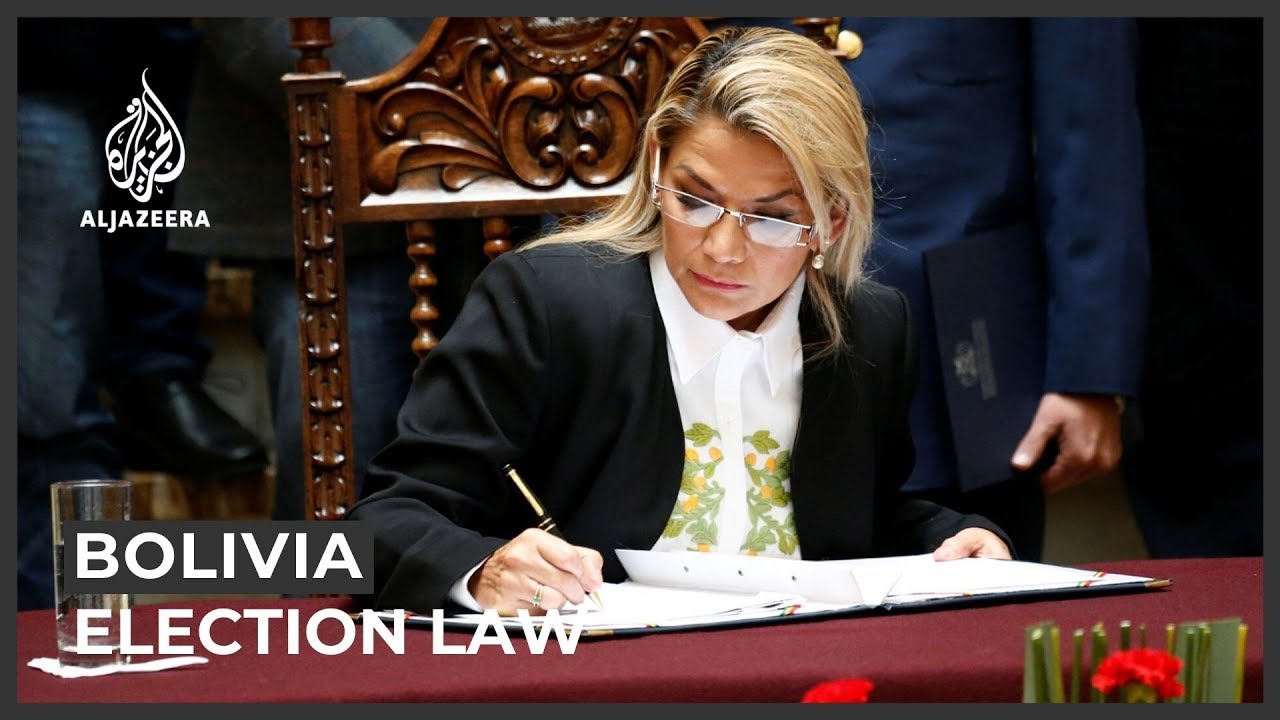 Bolivia unrest: Interim president signs election law