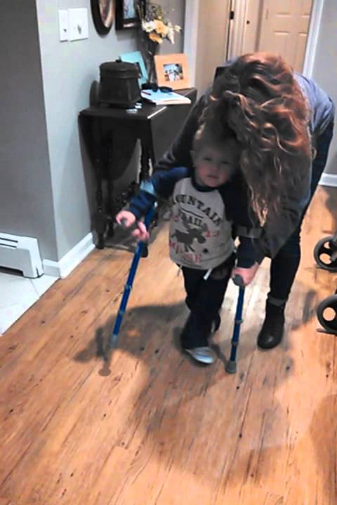 2 year old boy learning to walk with crutches