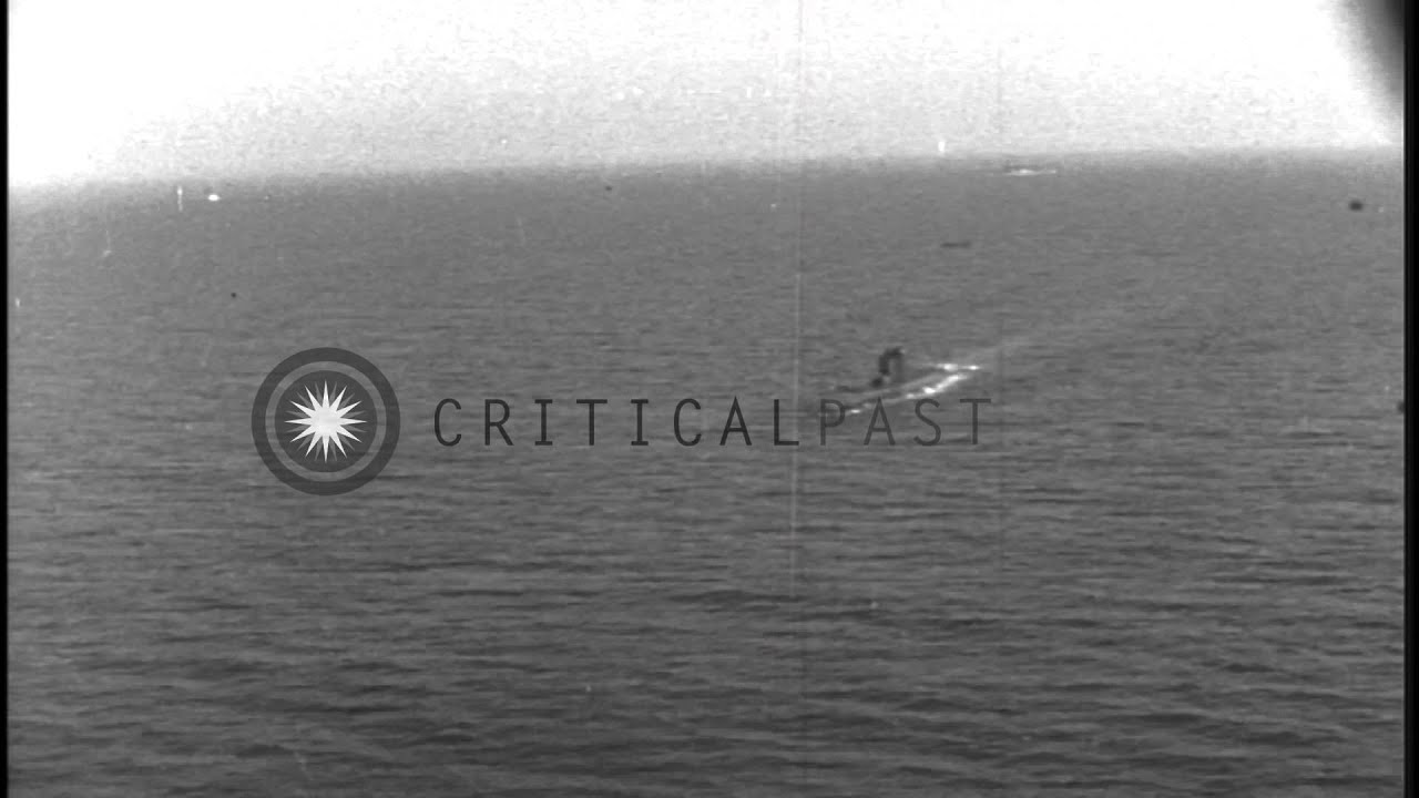 Aerial view of a US submarine underway and submerging in the Pacific Ocean. HD Stock Footage