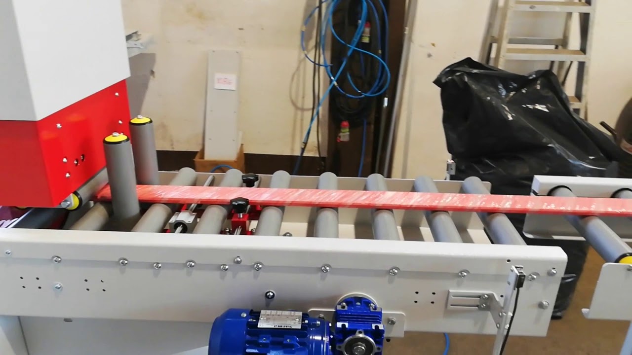 Automatic unloading and lateral storage system with belts for Orbital Stretch Wrapper