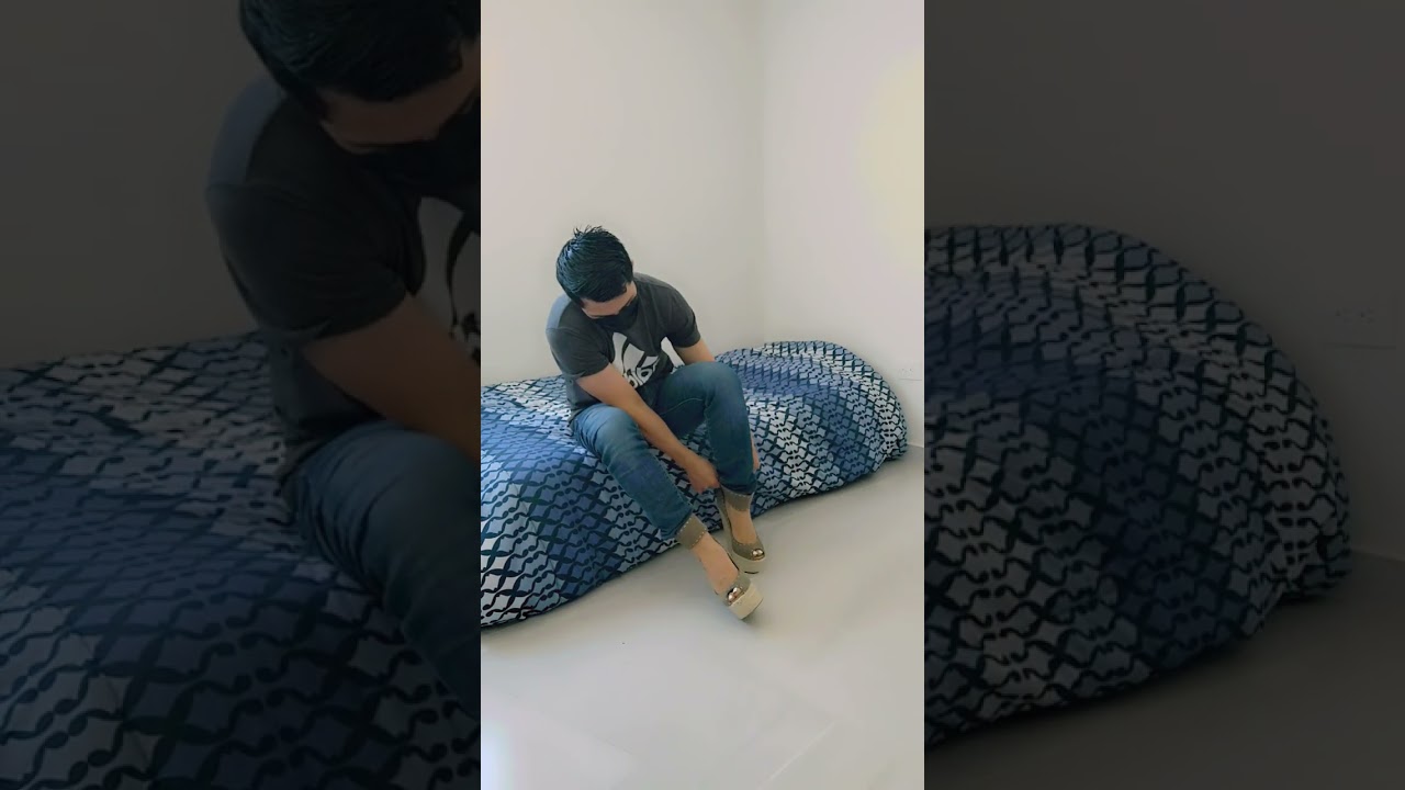 Boy putting on high heels wedges by Giuseppe Zanotti