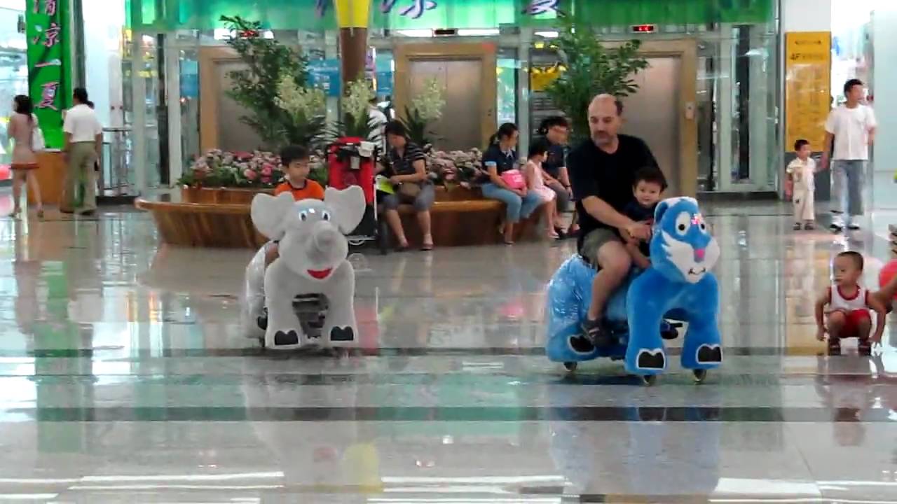 Children Riding Electric Animals at a Mall in Beijing, China
