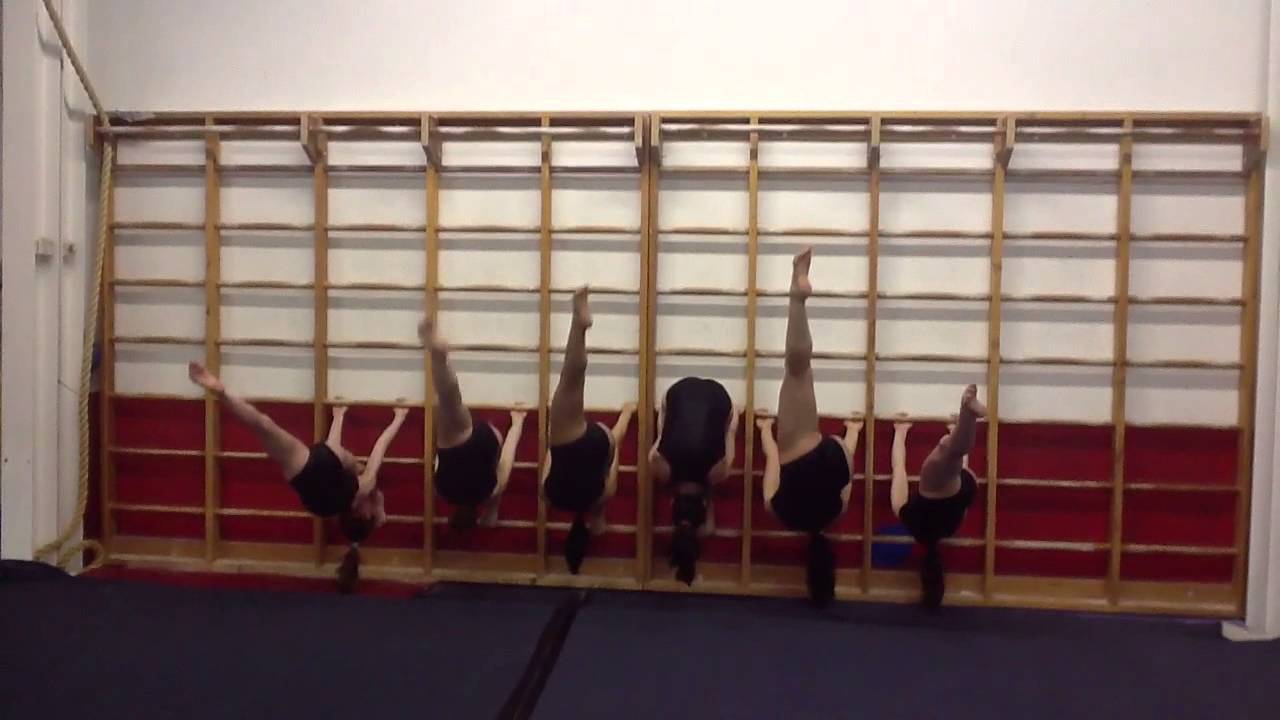 Flexibility using stall bars for pike stretch and split stretch