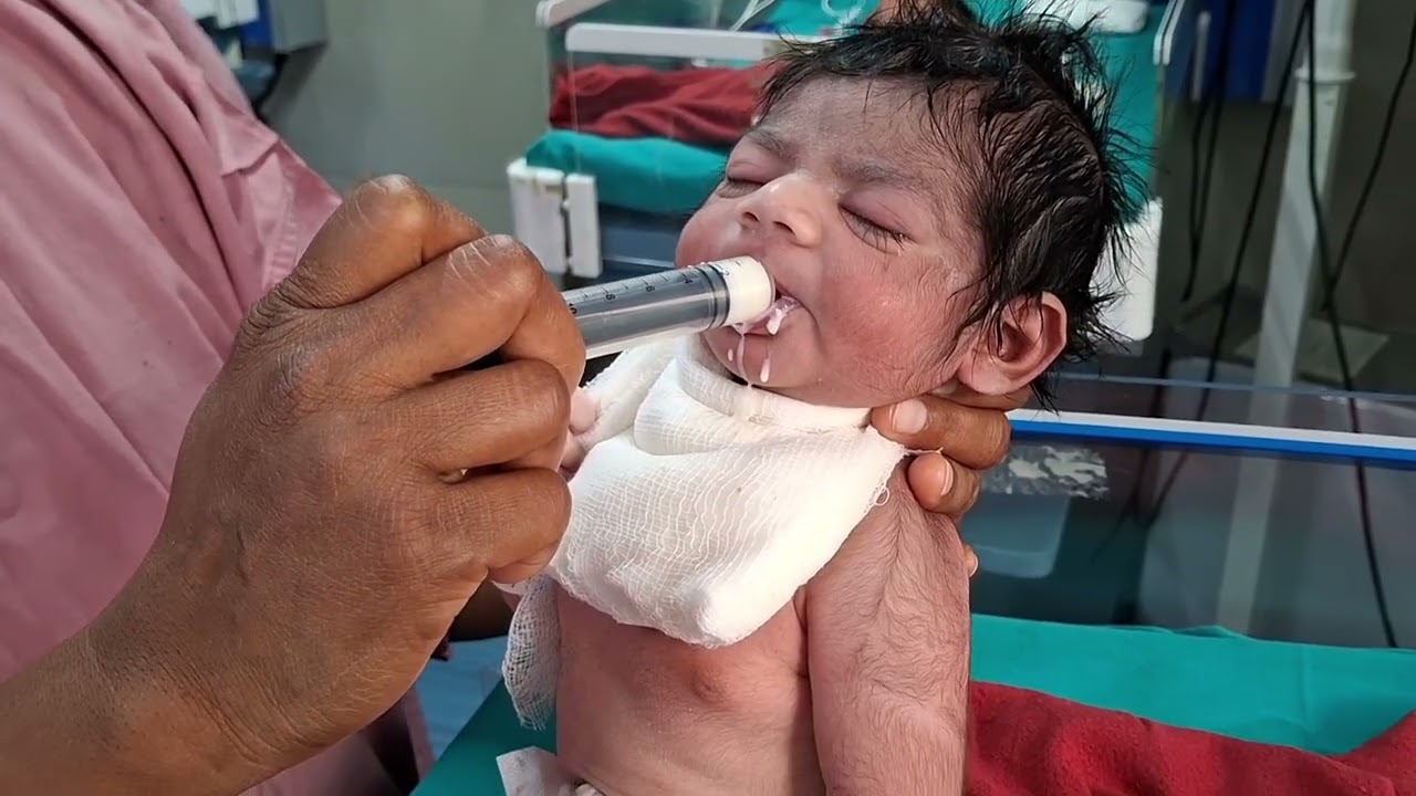 Tiny Beginnings – Newborn Baby Taking First Feeding by Syringe
