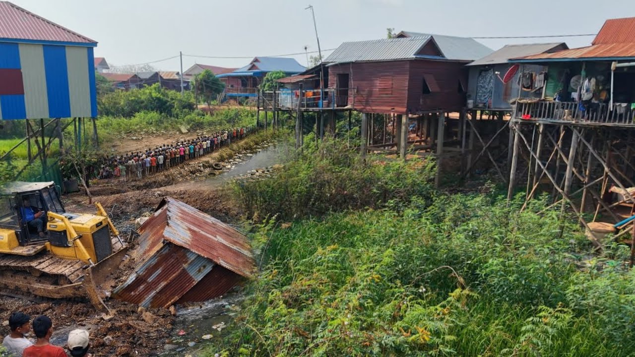 Great new project!! Completely 100% clearing, pushing soil, garbage in water the houses by Bulldozer