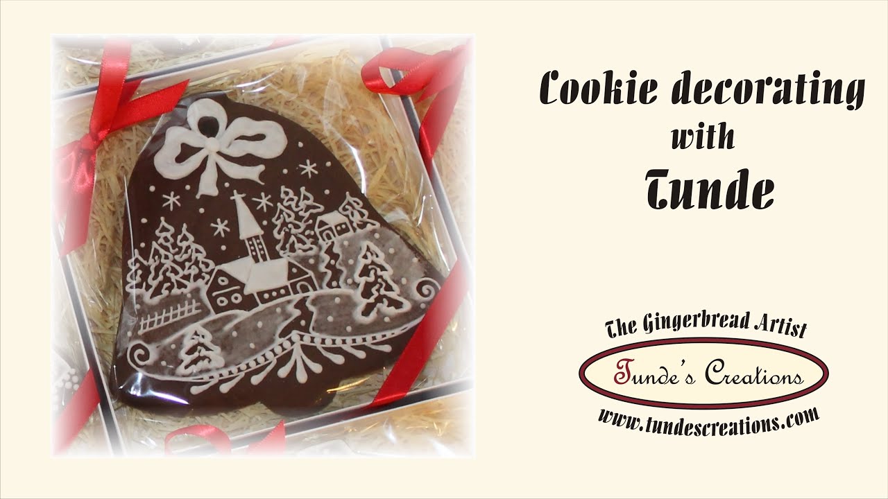 Decorating bell cookie with snowy landscape