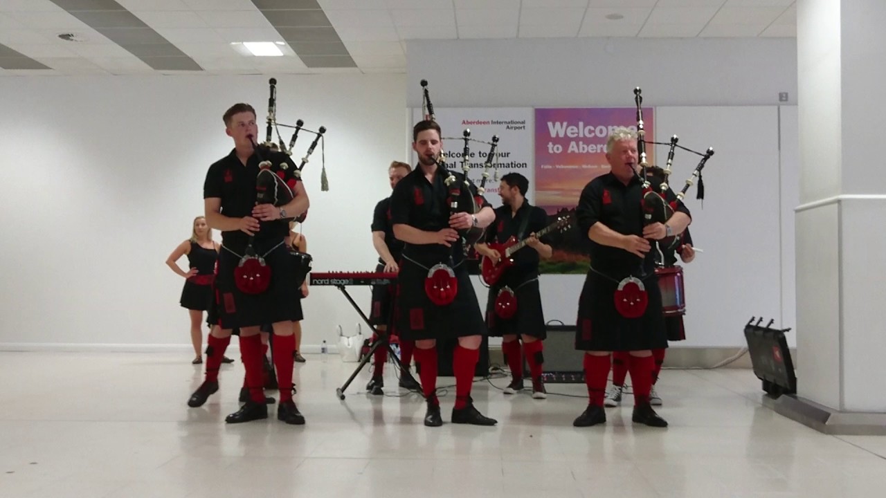 Red Hot Chilli Pipers performing at Aberdeen Airport - Chasing Cars by Snow Patrol