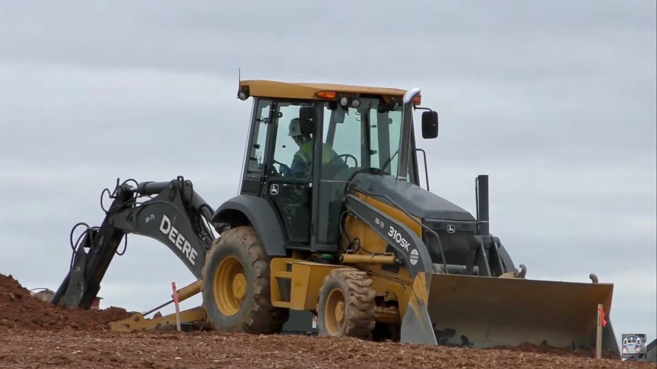 John Deere 310SK Backhoe Digging Trench