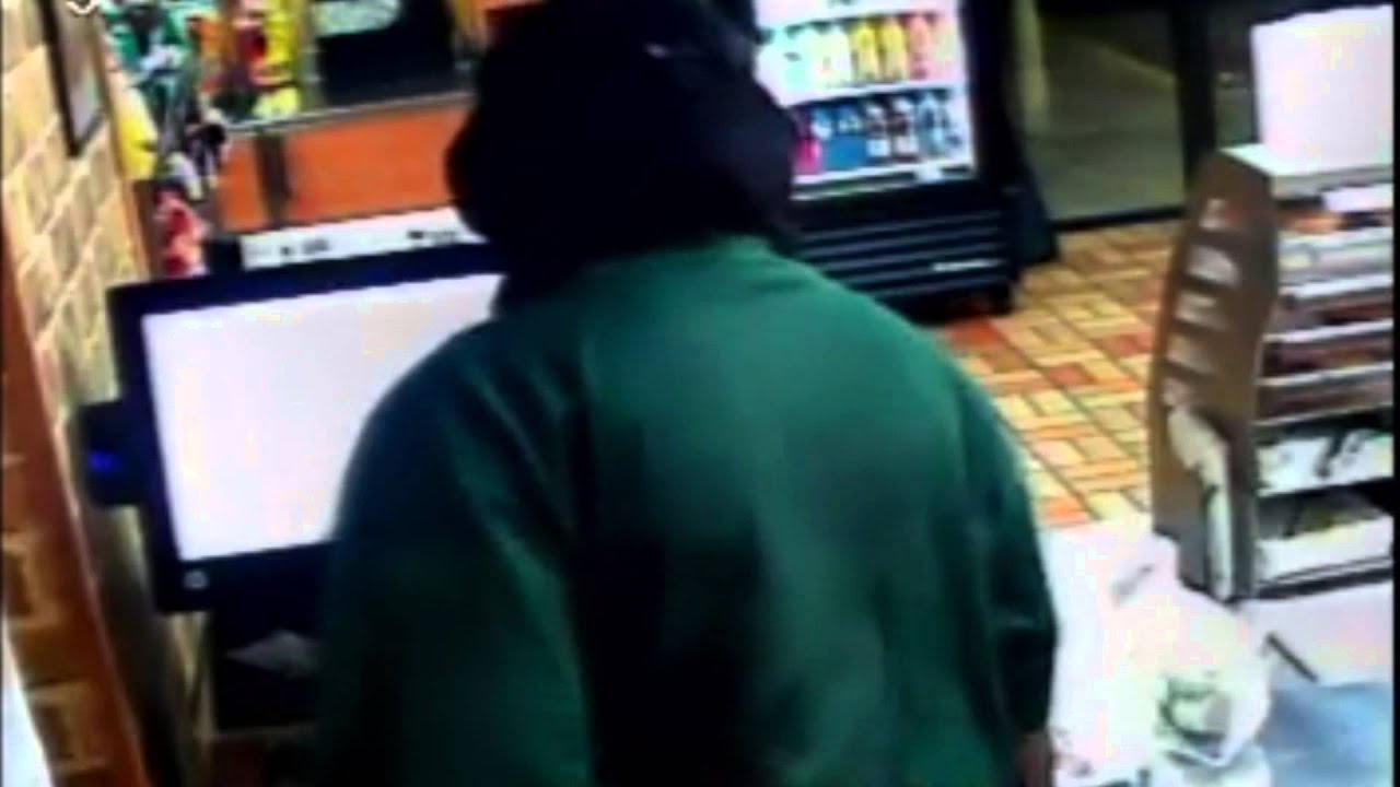 Surveillance footage shows an armed female suspect rob a Subway in Midfield