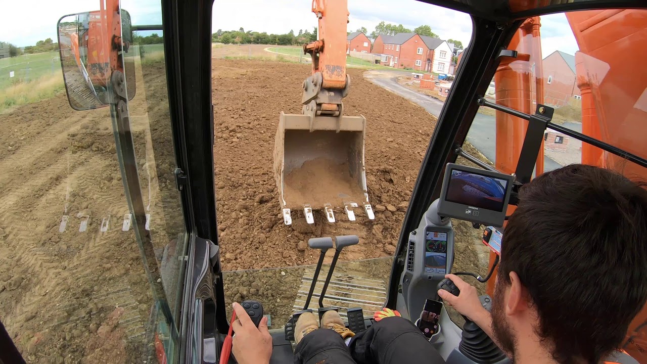 Excavator Hitachi 210 level top soil
