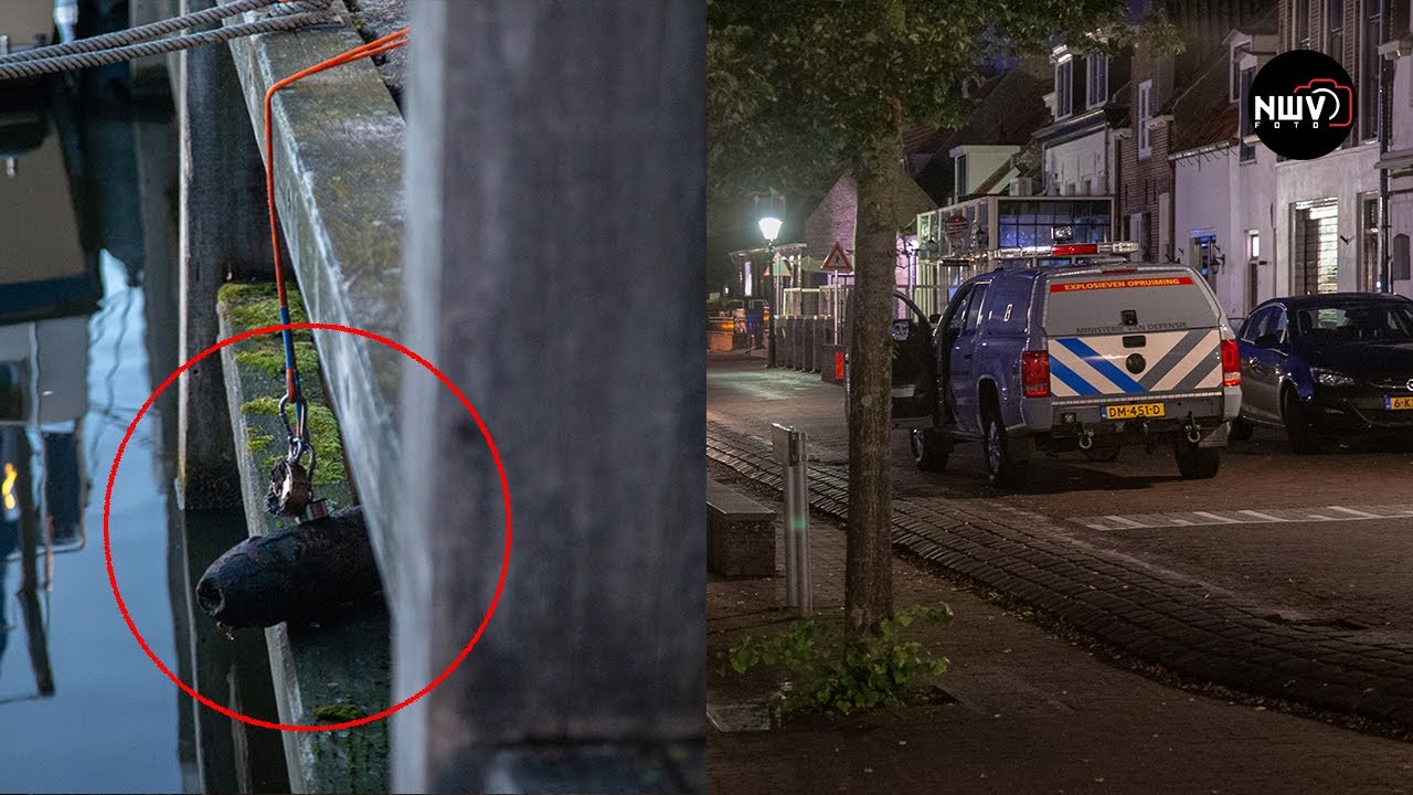 Toeristen vissen springgranaat uit haven Elburg tijdens het magneetvissen