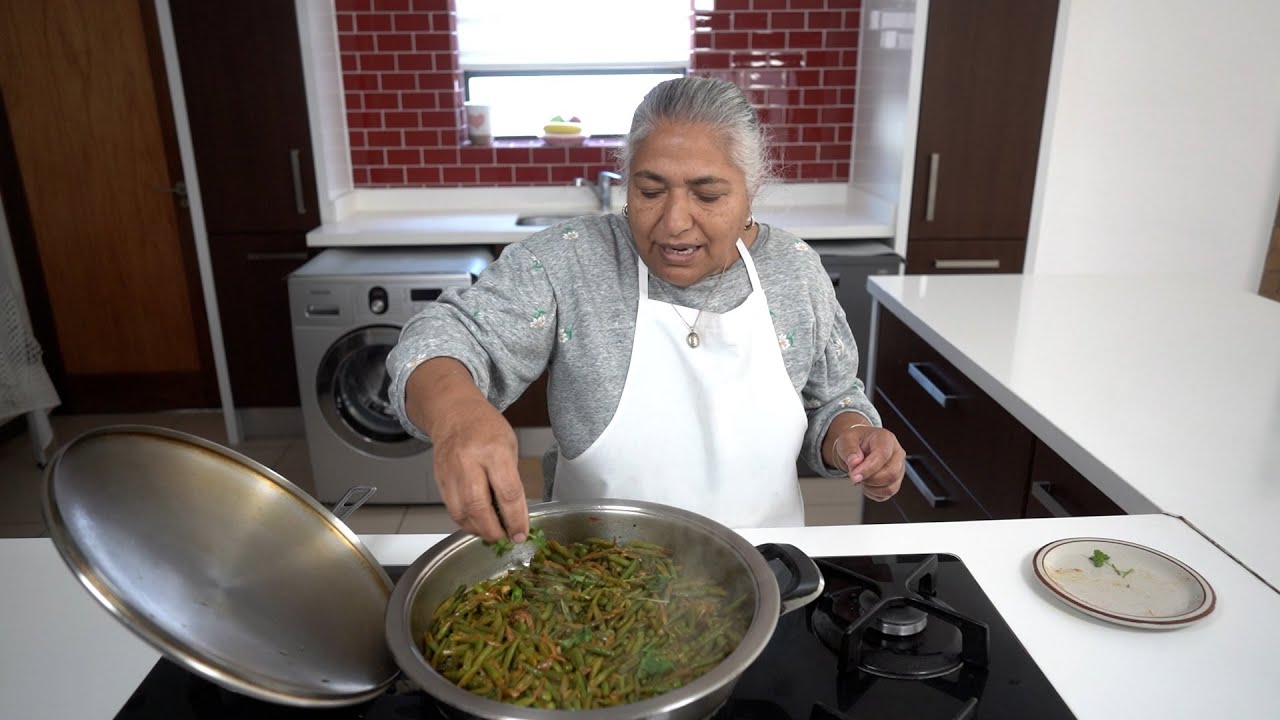 Making quick and easy green bean and pea masala fry