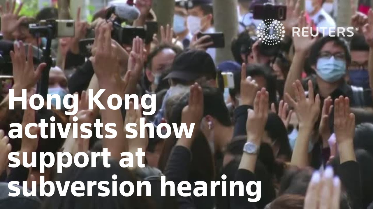 Hong Kong activists chant protest slogans as crowds gather for subversion hearing