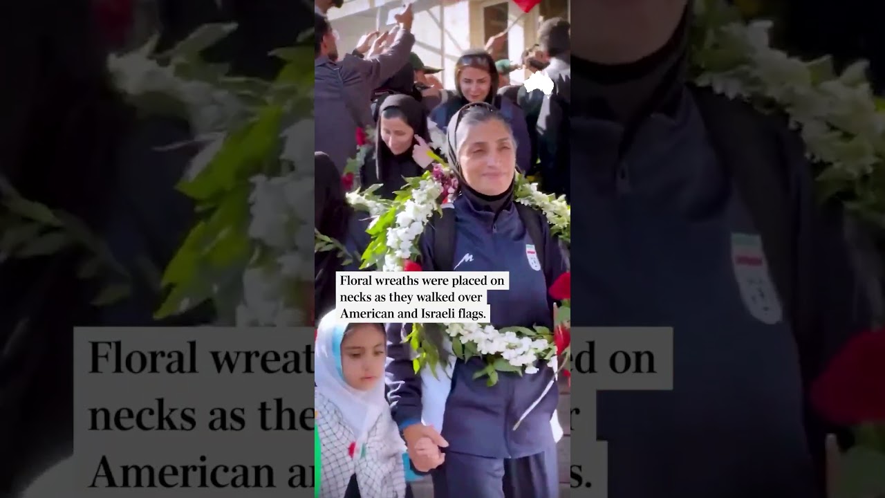 Iranian women's football team walk over US and Israeli flag on return home