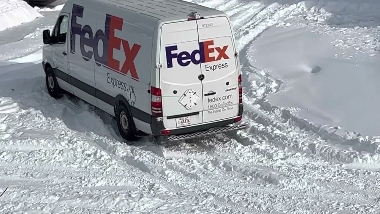 Fedex truck stuck on thick snow filled road