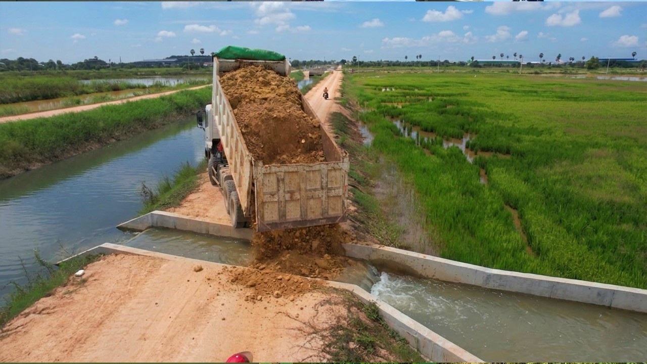 Light pole construction project By dozer shantui Pushing soil into the field & Truck 12-wheeler