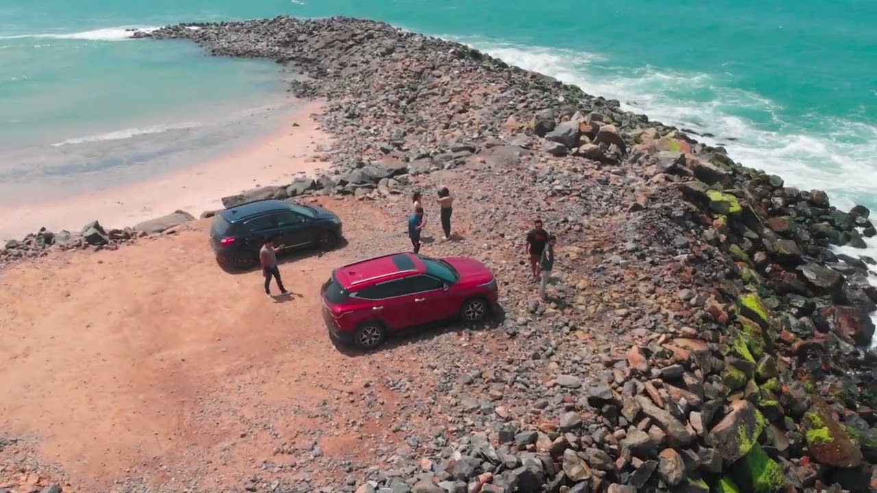 Two cars. Zero land left. Just us and the ocean clapping from three sides.