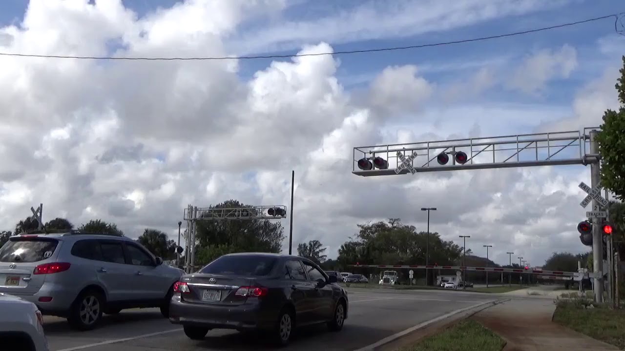 DRIVER SPEEDS THROUGH CROSSING TO MISS TRAIN - Pampano Park Pl. Railroad Crossing Pompano Beach, FL