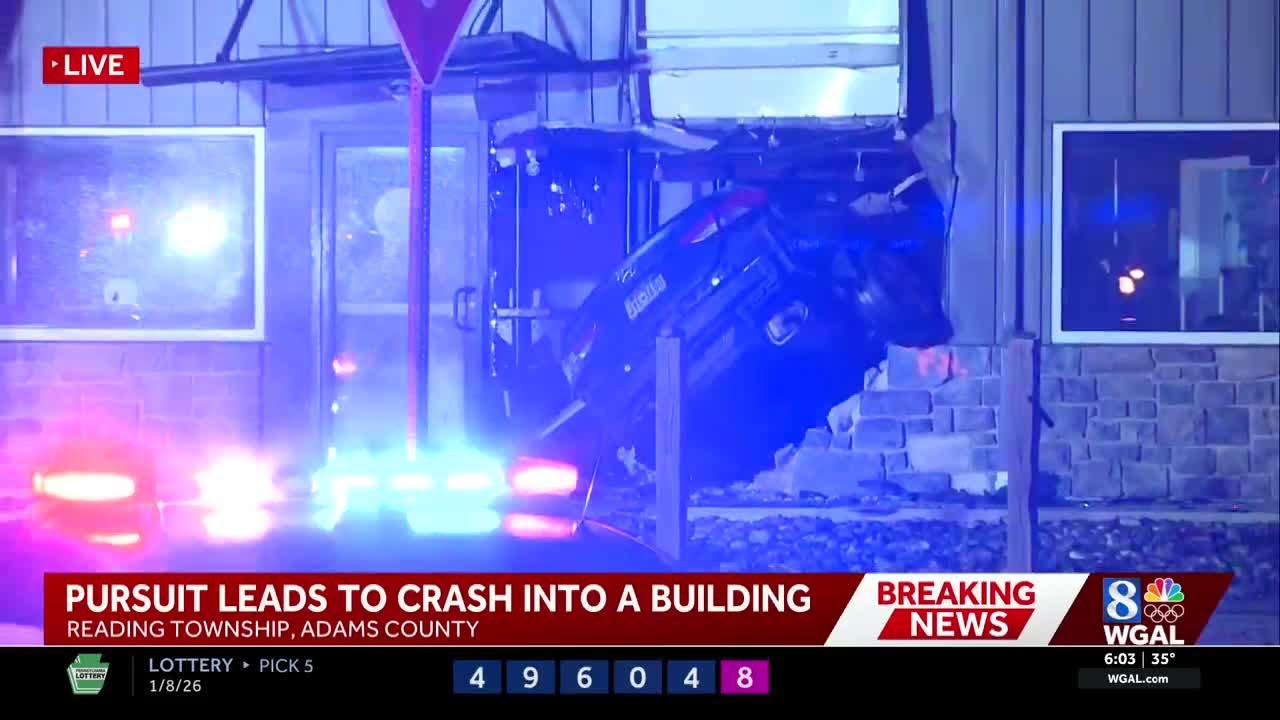 Police chase ends with vehicle lodged into Adams County building