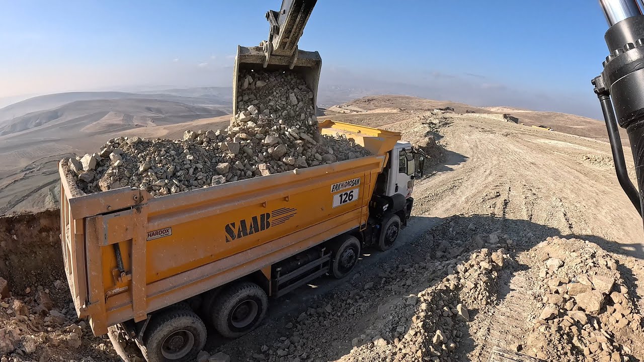 Hidromek Excavator Loading stony material.
